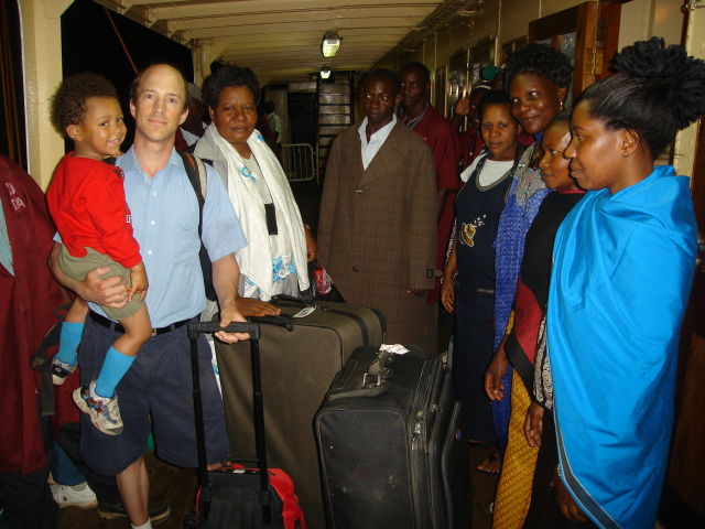 Greg and Joachim greeted by Joanitha's family on the ferry, Bukoba, Tanzania, 2008