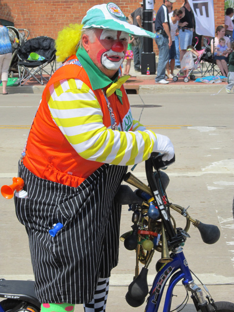 Clown on a bike in Memorial Day parade, DePere, Wisconsin, 2011