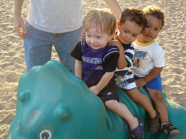 Dylan, Tariq and Joachim on a dinosaur, Fort Collins, Colorado, 2007