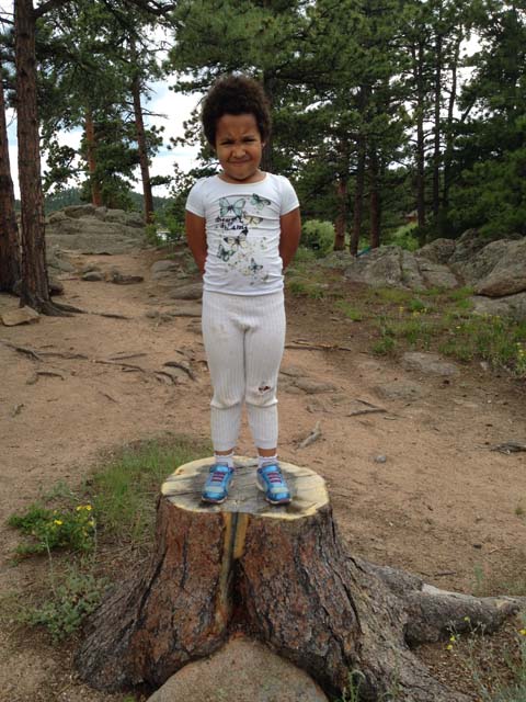 Irene on a tree stump, Red Feather Lakes, Colorado, 2019