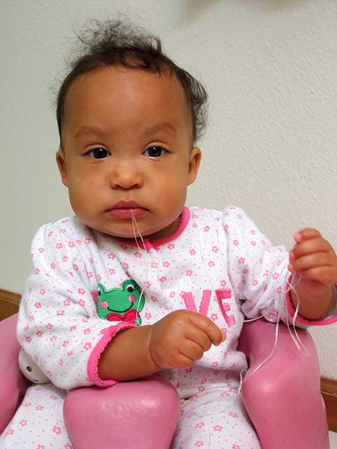 Irene flossing her teeth at 9 months, Fort Collins, Colorado, 2014