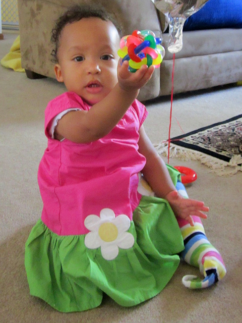Irene at 12 months with colored plastic toy, Fort Collins, Colorado, 2014