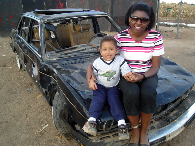 Joanitha and Joachim on a smashed car, Fort Collins, Colorado, 2008