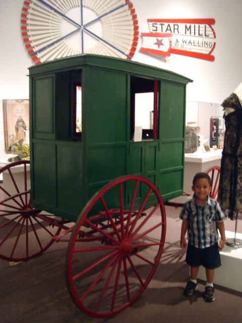 Joachim by a carriage in a museum, Albuquerque, New Mexico, 2009