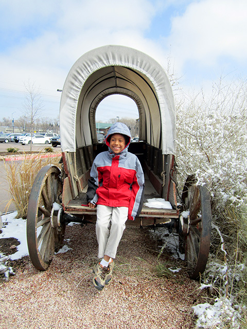 Joachim in a covered wagon outside the Ghost Town Museum, Colorado Springs, Colorado, 2014