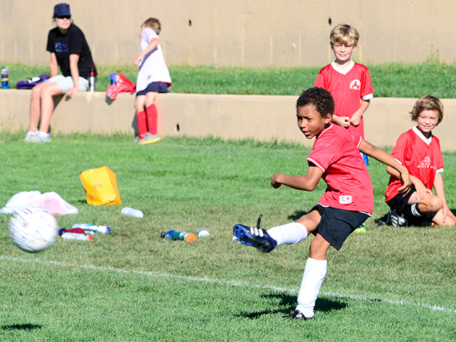 Joachim kicking a soccer ball, Fort Collins, Colorado, 2013