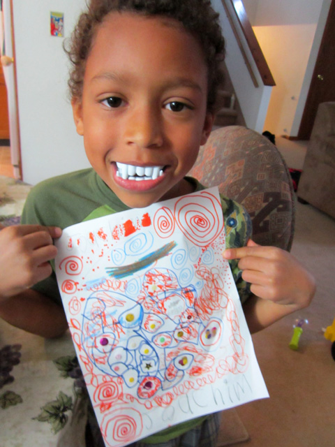 Joachim with vampire teeth and drawing, Fort Collins, Colorado, 2011