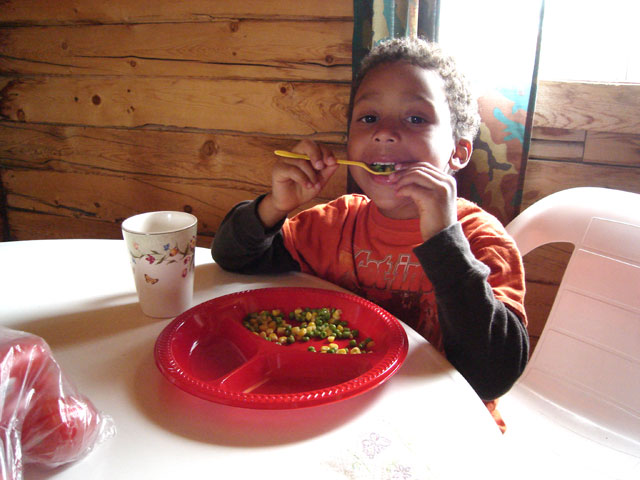 Joachim eating his vegetables in a cabin, Great Sand Dunes National Park, Colorado, 2010