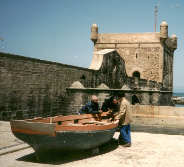 three men talking by a boat, Essaouira, Morocco, 1992