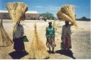 women carrying bundles of thatch (grass), Oshikango, Namibia, 1996