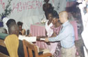 Greg and Joanitha receiving a bible at the sendoff party, Bukoba, Tanzania, 2003