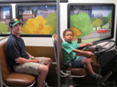Greg and Joachim on a bus, Milwaukee Children's Museum, Milwaukee, Wisconsin, 2011