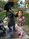 Irene with statues at the public library, Fort Collins, Colorado, 2016