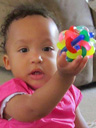 Irene at 12 months with colored plastic toy, Fort Collins, Colorado, 2014