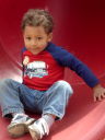 Joachim on a red slide at Rolland Moore Park, Fort Collins, Colorado, 2008