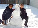 Joachim and Tariq with snowman, Fort Collins, Colorado, 2015