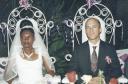 Greg and Joanitha seated at wedding reception, Bukoba, Tanzania, 2003